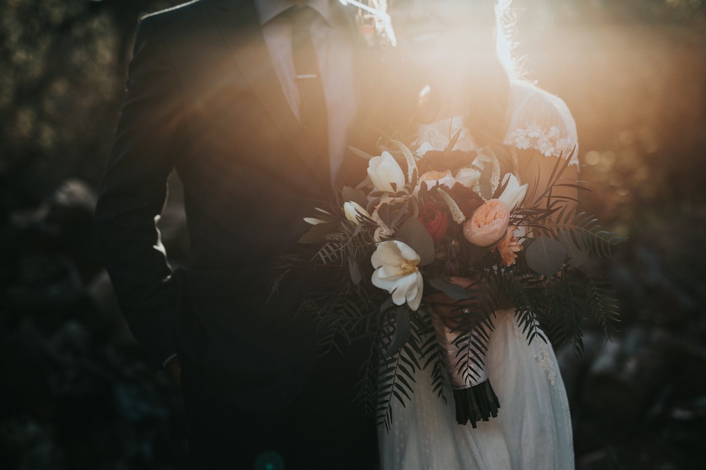 Couple backlit at golden hour during a celebration.