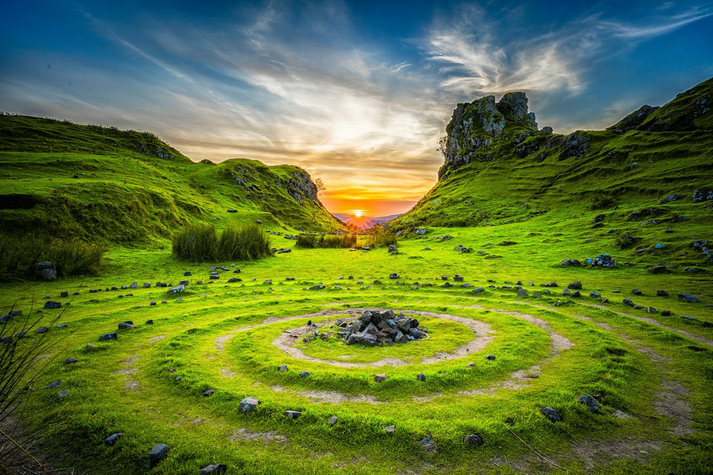 Rolling green hills at sunset.