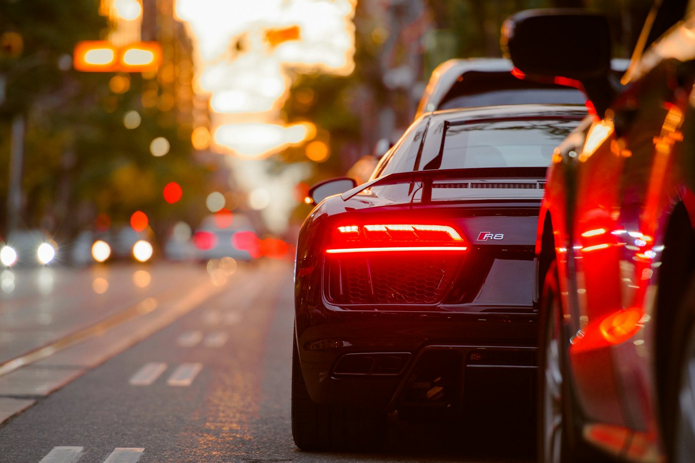 Tail lights streaking through a city street at night.