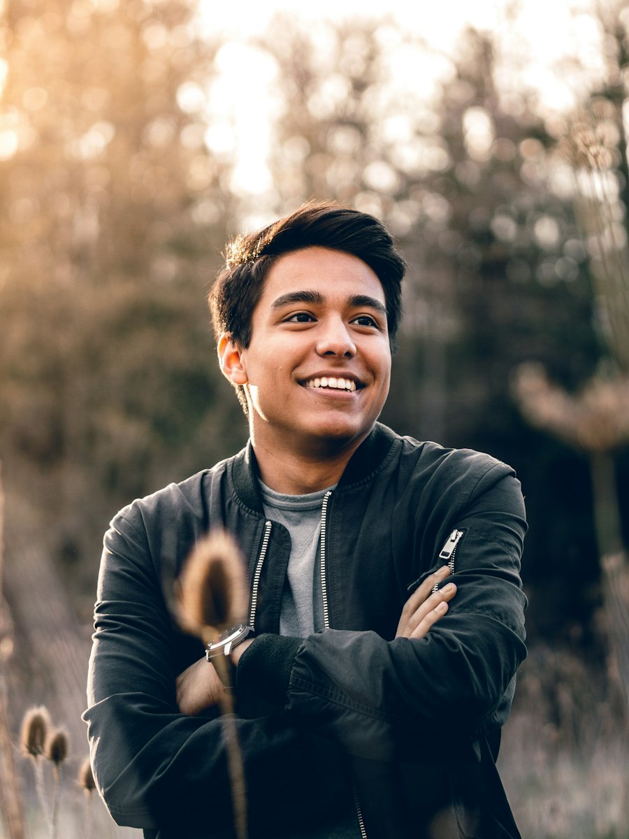 Backlit portrait of a man outdoors at golden hour.
