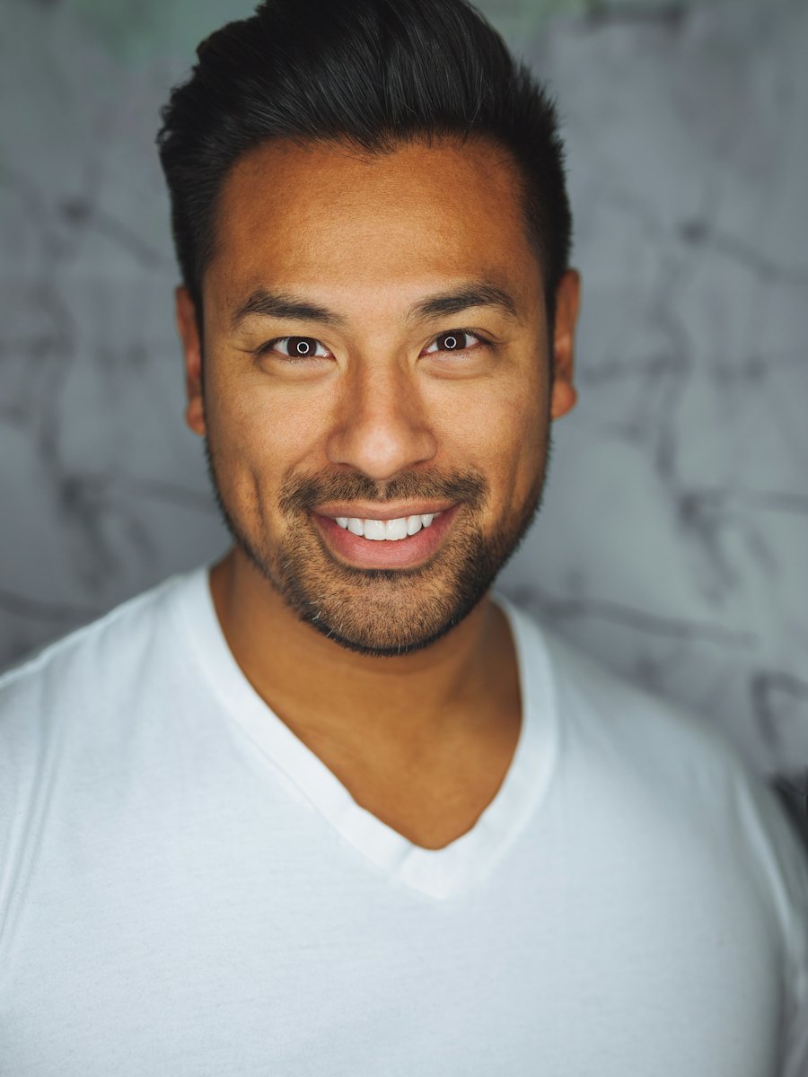Relaxed portrait of a man smiling outdoors.